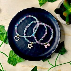 Cute blue, pink and teal, clear bead bracelet with random charm